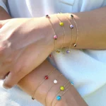 Bracciale oro giallo nove carati con coccinella rosa